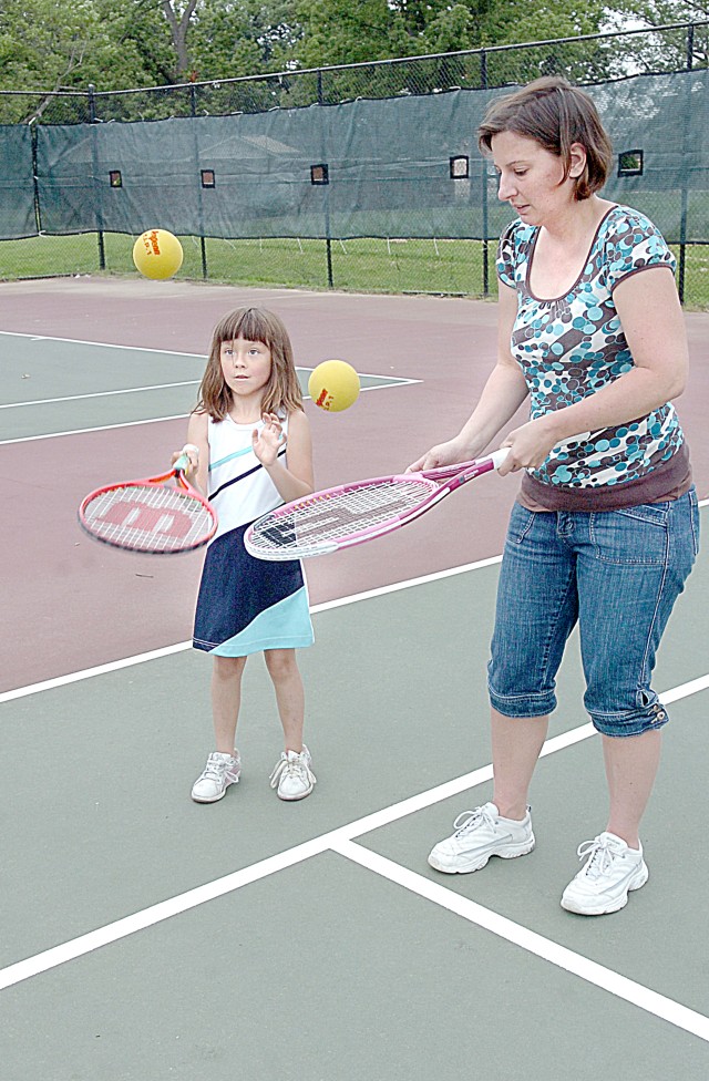 Families learn tennis together through program