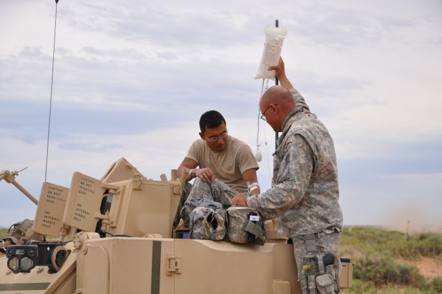 Medic gives AETF Soldier IV fluids