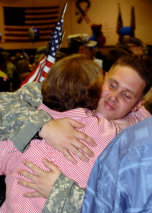 A 602nd Maintenance Company, 49th Transportation Battalion, 15th Sustainment Brigade, 13th Sustainment Command (Expeditionary), Soldier is welcomed home at a redeployment ceremony at Kieshnick Physical Fitness Center here, June 24. (U.S. Army...