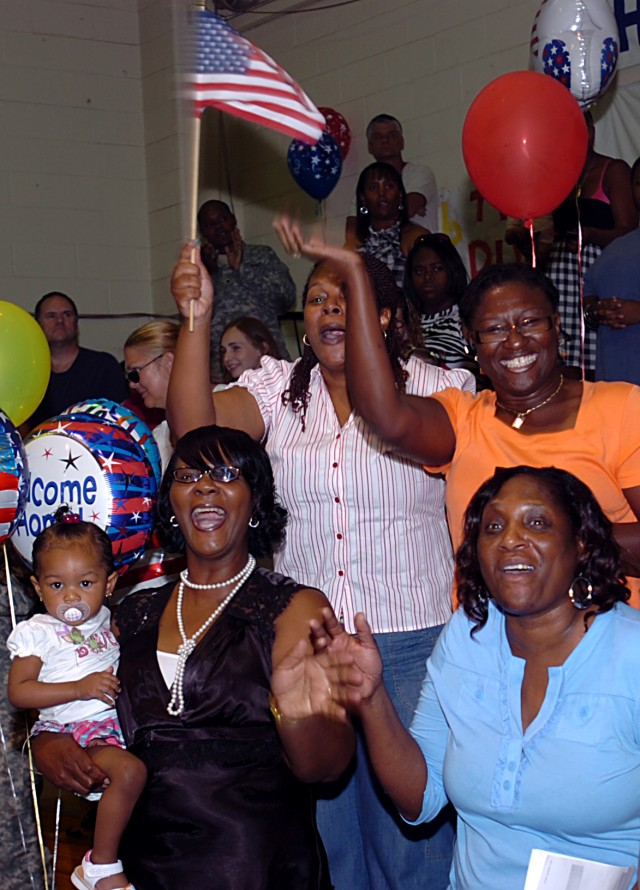 Family and friends of 602nd Maintenance Company, 49th Transportation Battalion, 15th Sustainment Brigade, 13th Sustainment Command (Expeditionary), Soldiers cheer as they see their Soldiers again for the first time in months at a redeployment...