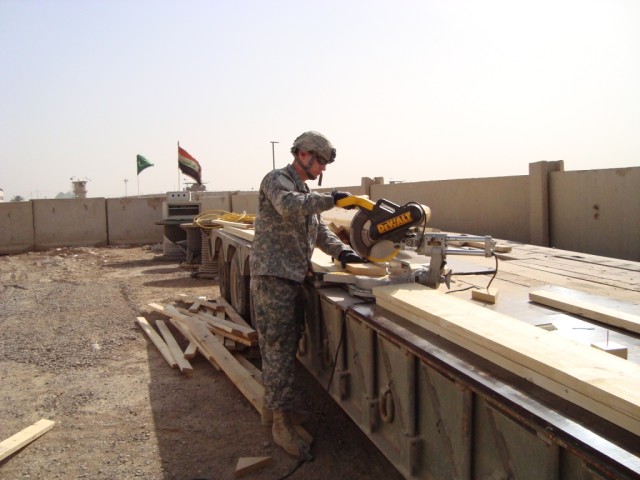 BAGHDAD - Spc. Robert Shoults, carpentry/masonry specialist from Berkeley, Mo., 46th Engineer Combat Battalion (Heavy), 225th Engineer Brigade, uses a miter saw while constructing the Joint Operations Center at Joint Security Station Shield. Since...