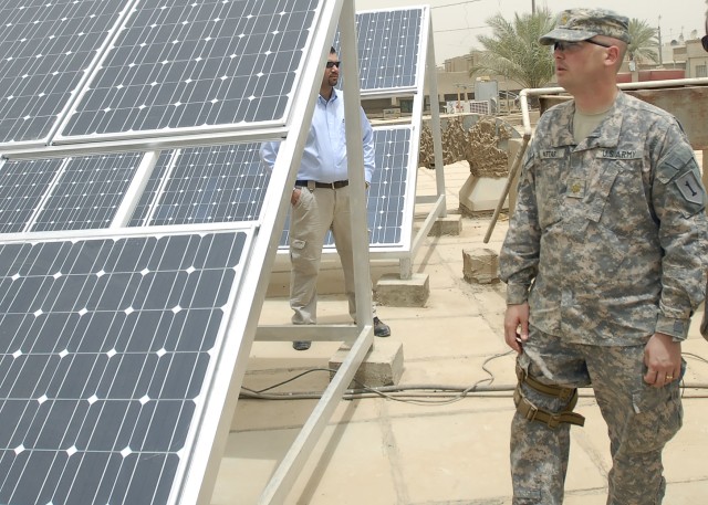 BAGHDAD - Maj. Andrew Attar, a native of Bristol, Conn., joint project management officer, 2nd Heavy Brigade Combat Team, 1st Infantry Division, Multi-National Division - Baghdad, inspects the newly installed solar panels on the roof of the Dahkel...