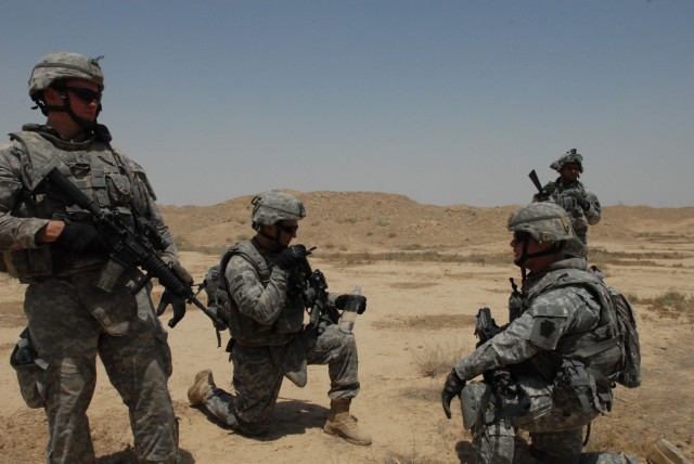 NUBAI, Iraq - Staff Sgt. Christopher Lohr (left) of Springfield, Pa., 1st Lt. Eric Ponzek (kneeling, center) of Collegeville, Pa. and Capt. John Mance (kneeling, right) of Norristown, Pa., commander of Headquarters and Headquarters Company, 1st...