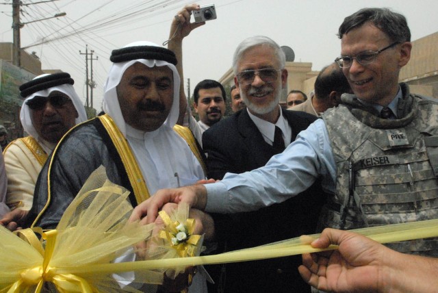 BAGHDAD, Iraq - Sheik Ali mejbel Al-ghreer (left), the Rabee packing shed owner, Tracy Atwood (center), Falls Village, Conn. native, Inma Chief of Party, and Stockton, Calif. native Glen Keiser (right), the embedded Provincial Reconstruction Team...