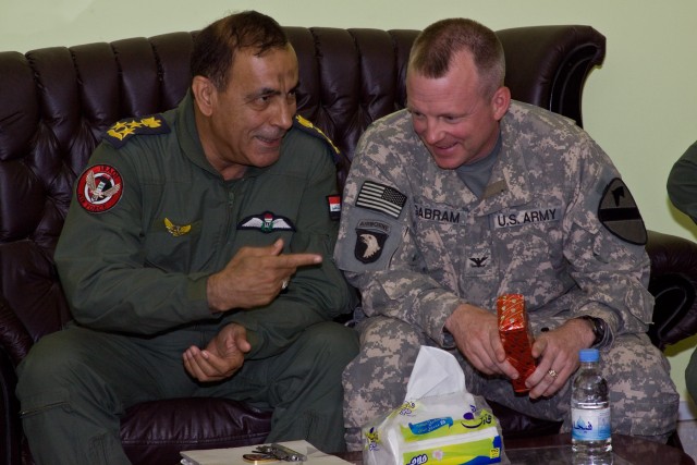 AL-TAJI AIRBASE, Iraq-In a gesture of appreciation, Brig. Gen. Nadhem Lafte al-AJwdi (left), of the Iraqi Air Force, commander of al-Taji Airfield, gives a gift to Col. Douglas Gabram (right), from Cleveland, Ohio, commander of the 1st Air Cavalry...