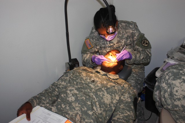 Staff Sgt. Jonathen Engram, a radar operating specialist assigned to the 5th Battalion, 82nd Field Artillery Regiment, 4th Brigade Combat Team, 1st Cavalry Division, receives a dental x-ray examination during his Reverse Soldier Readiness...