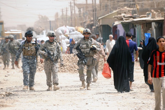 BAGHDAD - Paratroopers assigned to Company A, 2nd Battalion, 505th Parachute Infantry Regiment, 3rd Brigade Combat Team, 82nd Airborne Division, Multi-National Division - Baghdad, along with National Police officers walk the Baghdad suburb of...