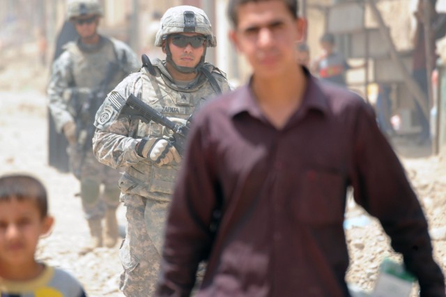 BAGHDAD - Sgt. Anthony E. Zapata, of Corpus Christi, Texas, a team leader with Company A, 2nd Battalion, 505th Parachute Infantry Regiment, 3rd Brigade Combat Team, 82nd Airborne Division, Multi-National Division - Baghdad, checks his surroundings...