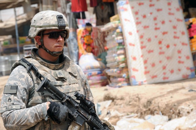 BAGHDAD - Staff Sgt. Oliver Nied, a squad leader with Company A, 2nd Battalion, 505 Parachute Infantry Regiment, 3rd Brigade Combat Team, 82nd Airborne Division, Multi-National Division - Baghdad, walks of streets of the city of Oubaidy during a...