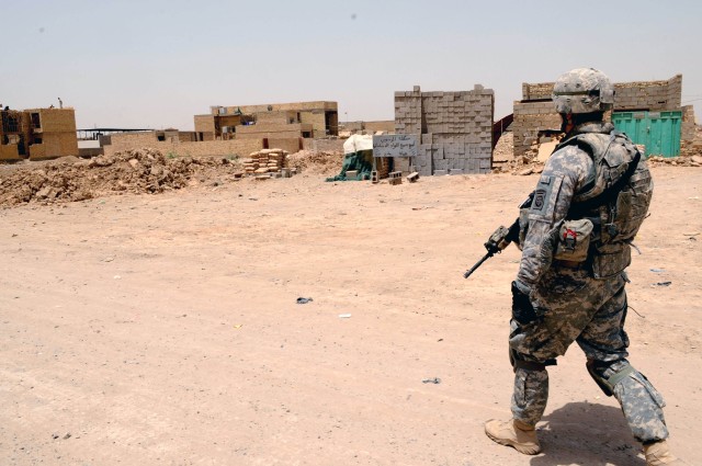 BAGHDAD - A Paratrooper assigned to Company A, 2nd Battalion, 505 Parachute Infantry Regiment, 3rd Brigade Combat Team, 82nd Airborne Division, Multi-National Division - Baghdad, overlooks some pre-constructed house in the poverty-stricken region...