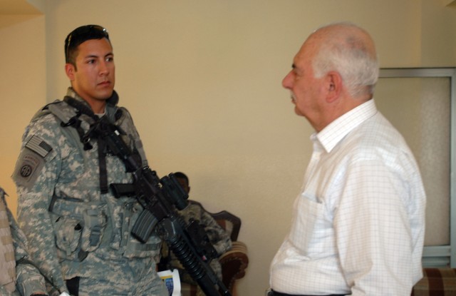 Master Sgt. Felipe Azua, of Plainview, Texas, a team chief with Company B, 410th Civil Affairs, speaks with Kirkuk Chamber of Commerce director Sabah Alden Mohammed Salih al Salhi about a business project that will provide the Chamber of Commerce wit...