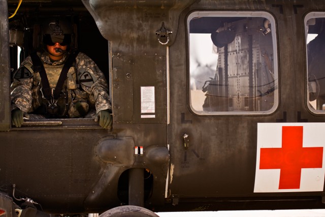 CAMP TAJI, Iraq-During the initial run up, before taking over the day's mission, Sgt. Randy Sanchez, from Rio Grande City, Texas, a flight medic in C Company "Medevac," 2nd Battalion, 1st Air Cavarly Brigade, 1st Cavarly Division, sits in a UH-60...