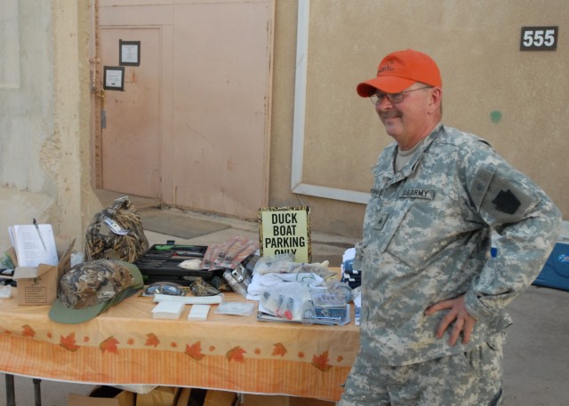 CAMP TAJI, Iraq - Sgt. John Chrzanowski, of Erie, Pa., with Headquarters and Headquarters Company, 1st Battalion, 112th Infantry, 56th Stryker Brigade Combat Team, Pennsylvania Army National Guard, stands next to a table of donated Ducks Unlimited me...