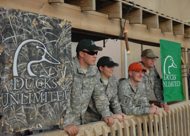 CAMP TAJI, Iraq - New Ducks Unlimited members sport DU hats following the business portion of the inaugural cookout meeting of the Camp Taji Chapter of Ducks Unlimited, June 13. These new members are, from left: Sgt. Trevor Onukiavage, of Carlisle, P...
