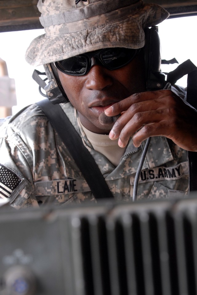 BAGHDAD - Sgt. Andrew Lane, a transportation specialist from Mansfield, La., assigned to Company A, 299th Brigade Support Battalion, 2nd Brigade, 1st Infantry Division, performs radio checks with the battalion tactical operation center prior to the c...