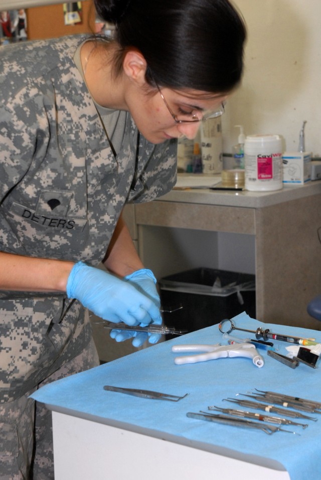 BAGHDAD - As a high-pitched cachophony of dental drills buzz on the other side of the office, Spc. Lindsay Deters, a dental assistant with the 464th Medical Company (DS), 421st Multifunctional Medical Battalion, 44th Medical Command, Multi-National D...