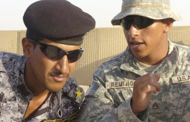 Staff Sgt. Damian Remijio, assigned to 5th Squadron, 73rd Cavalry, 82nd Airborne Division, advises a National Police lieutenant on tactical procedures during a training event, June 24, at Forward Operating Base Hammer, Iraq, located outside of easter...