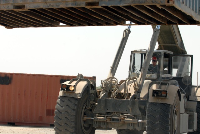 BAGHDAD - Sgt. Darrel Whitton, a Gouverner, N.Y. native, and automotive logistics Soldier assigned to Company A, 299th Brigade Support Battalion, 2nd Brigade, 1st Infantry Division, moves a conex with a Rough Terrain Container Handler (RTCH) at...