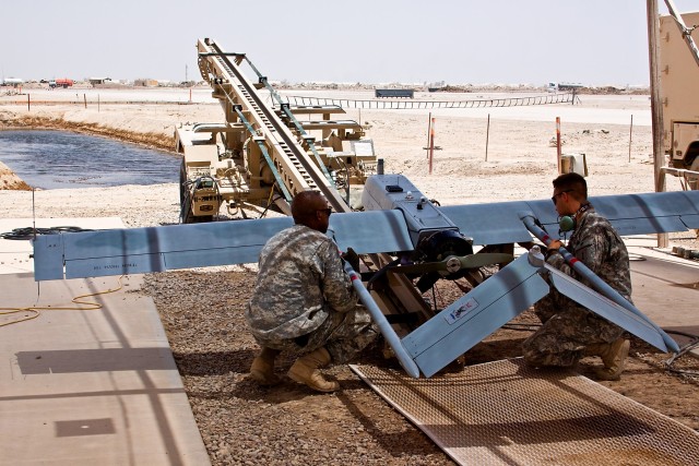 TAJI, Iraq - Prepping for a launch, Sgt. Donald Melvin (left), an unmanned aerial vehicle mechanic, from Columbus, Miss., a 1st Infantry Division Soldier attached to 2nd Battalion, 1st Air Cavalry Brigade, 1st Cavalry Division, Multi-National...