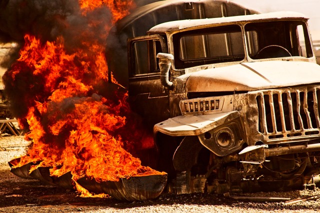 TAJI, Iraq - Fire fighters from Fire Station 1, Camp Taji, Iraq, set barrels surrounding a truck ablaze to simulate an aircaft fire for the Sodliers of 615th Aviation Support Battalion, 1st Air Cavalry Brigade, 1st Cavalry Division, Multi-National...