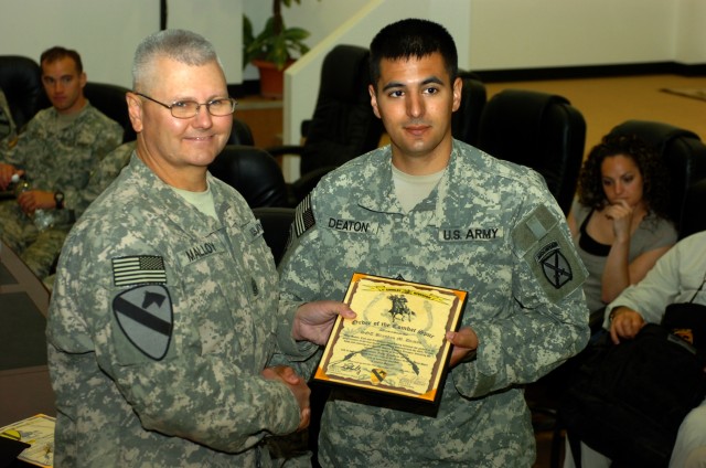 BAGHDAD - Command Sgt. Maj. Rory Malloy (left), senior enlisted advisor, 1st Cavalry Division and Multi-National Division-Baghdad, presents the Order of the Combat Spur to Topsham, Maine native, Sgt. Brandon Deaton, an infantryman with the 2nd Brigad...