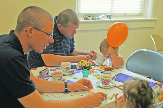 Daughters teach their fathers about tea party etiquette at ACS event