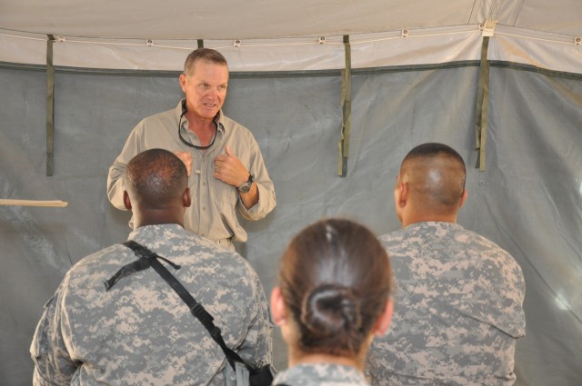 Tracy G. Watkins, a government contracted senior trainer, instructs Soldiers of the 57th Expeditionary Signal Battalion on the dangers of Mine Resistant Ambush Protected vehicle rollovers. Soldiers of the 57th ESB practiced rollover drills in an MRAP...