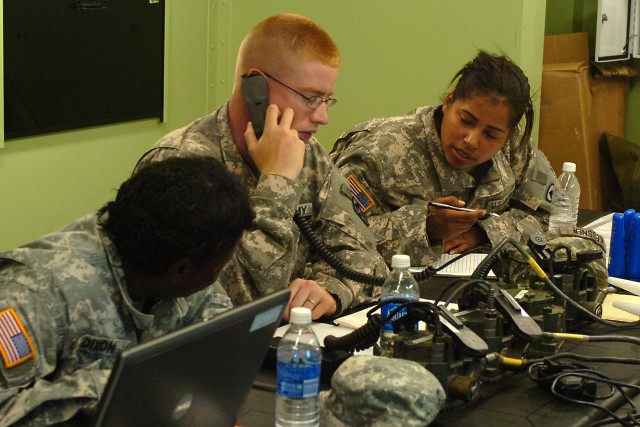 Staff Sgt. Kezia Dixon and Spc. Melissa Kessner, with the 15th Sustainment Brigade, coordinate for medics to respond to an event while Spc. Michael White, also with the 15th SB, talks with the medics on the radio during Freedom Fest at Hood Stadium J...