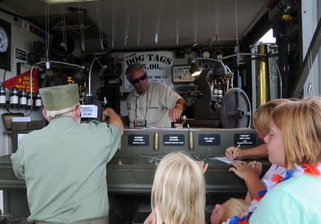 Brad Nelson, a member of the Military Vehicle Preservation Association 2009 Transcontinental Motor Convoy, creates dog tags for the crowd July 2, 2009. The MVPA 2009 TMC, which is traveling from Washington, D.C. to San Francisco, California to...