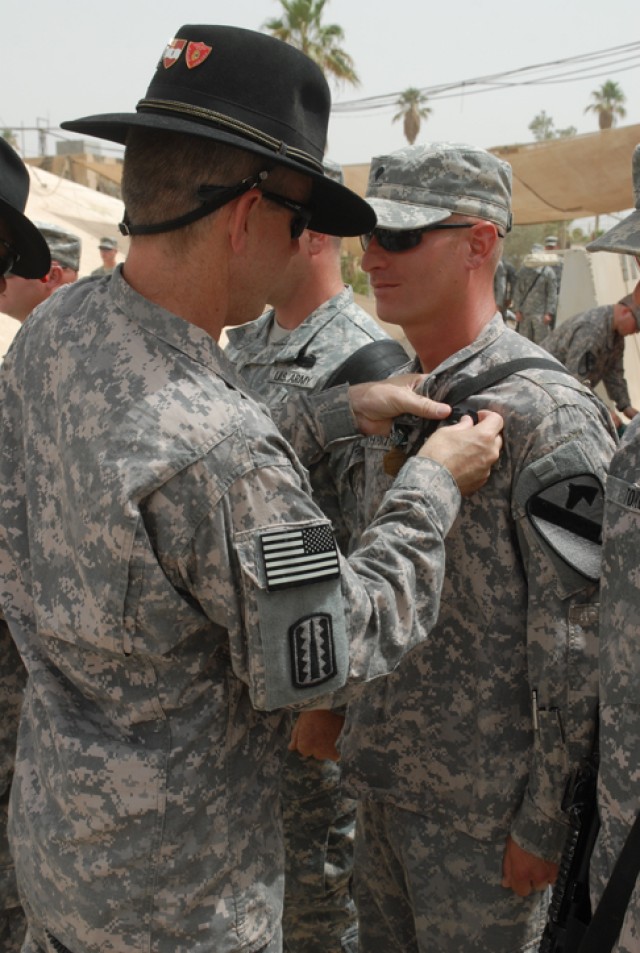 Spc. Rodney Thornton, a Houston native and gunner with Golf Forward Support Company, 3rd Battalion, 82nd Field Artillery Regiment, 2nd Brigade Combat Team, 1st Cavalry Division, has a combat action badge pinned to him by Lt. Col. Terry Cook, the...