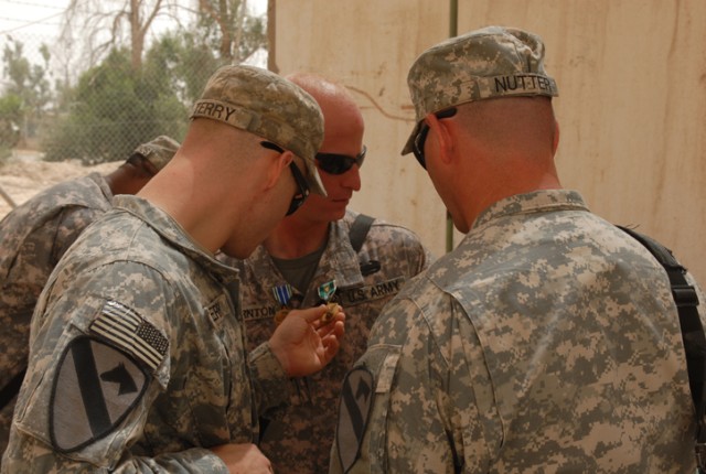 Fellow Soldiers check out new medals on Spc. Rodney Thornton, a Houston native and gunner with Golf Forward Support Company, 3rd Battalion, 82nd Field Artillery Regiment, 2nd Brigade Combat Team, 1st Cavalry Division, which he received June 26 on...