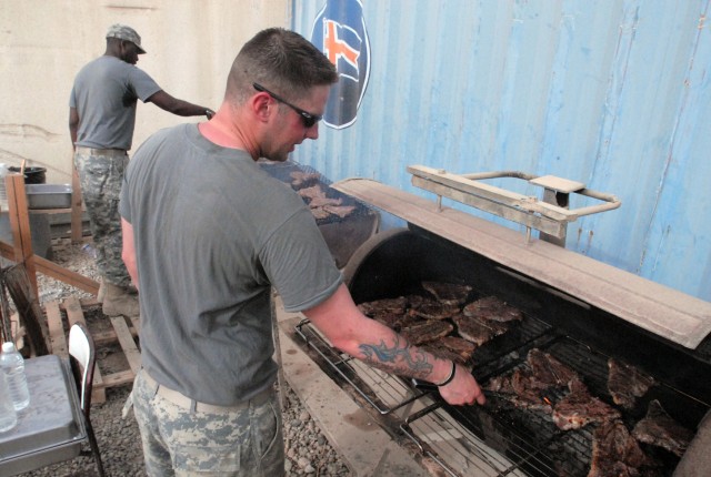 Spc. Robert Mullinex Chicago native and Sgt. Edward Leak of Newport News, Va., both food service specialists with 1st Battalion, 8th Cavalry Regiment, 2nd Brigade Combat Team, 1st Cavalry Division, grill steaks at Forward Operating Base McHenry, Kirk...