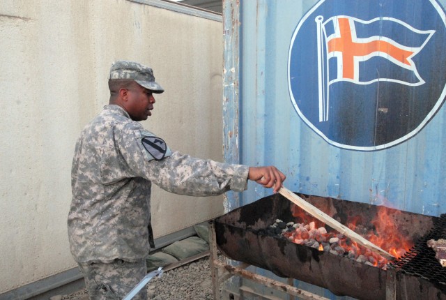 Staff Sgt. George Crocker, Chesapeake, Va. native, a food service specialist with 1st Battalion, 8th Cavalry Regiment, 2nd Brigade Combat Team, 1st Cavalry Division, stokes the coals in preparation for a barbeque at Forward Operating Base McHenry, Ki...