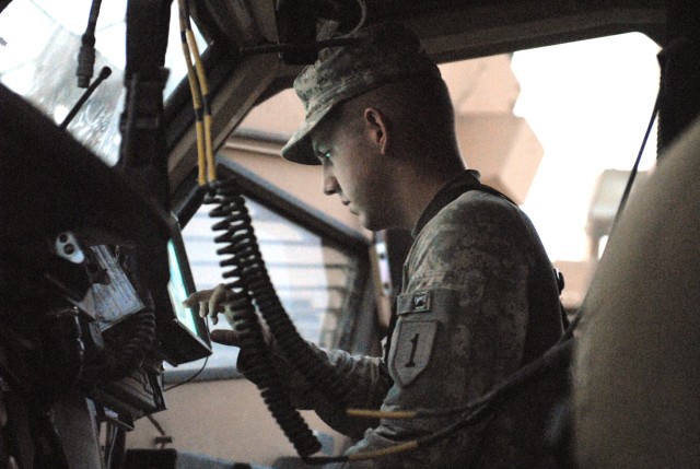 BAGHDAD - Cpl. Dustin Spear, of Placerville, Calif., a convoy security detachment team leader assigned to Headquarters and Headquarters Company, 299th Brigade Support Battalion, 2nd Brigade, 1st Infantry Division performs checks on a blue force...