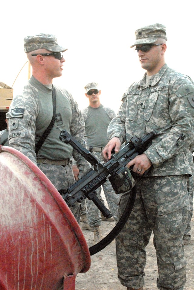 BAGHDAD - Sgt. Tommy Evans, of Hereford, Texas, convoy security detachment noncommissioned officer in charge assigned to Headquarters and Headquarters Company, 299th Brigade Support Battalion, 2nd Brigade, 1st Infantry Division watches as Spc....