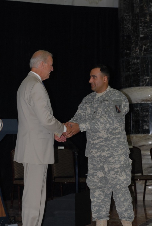 BAGHDAD - Iraqi-born U.S. Soldier turned American citizen, Spc. "Brown" (right), an interpreter attached to the 225th Engineer Brigade, shakes hands with Vice President Joe Biden during a naturalization ceremony at Camp Liberty, Iraq July 4. Brown...