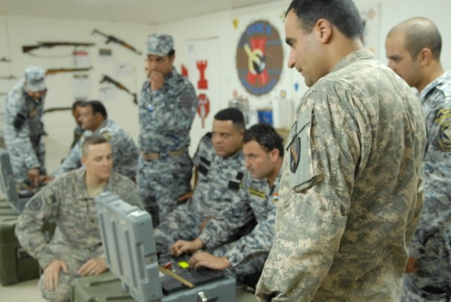BAGHDAD - Iraqi-born U.S. Soldier turned American citizen, Spc. "Brown" (right), interpreter for the 225th Engineer Brigade, served as a translator during the training of members of Iraq's 2nd National Police in a recent Army engineering route...