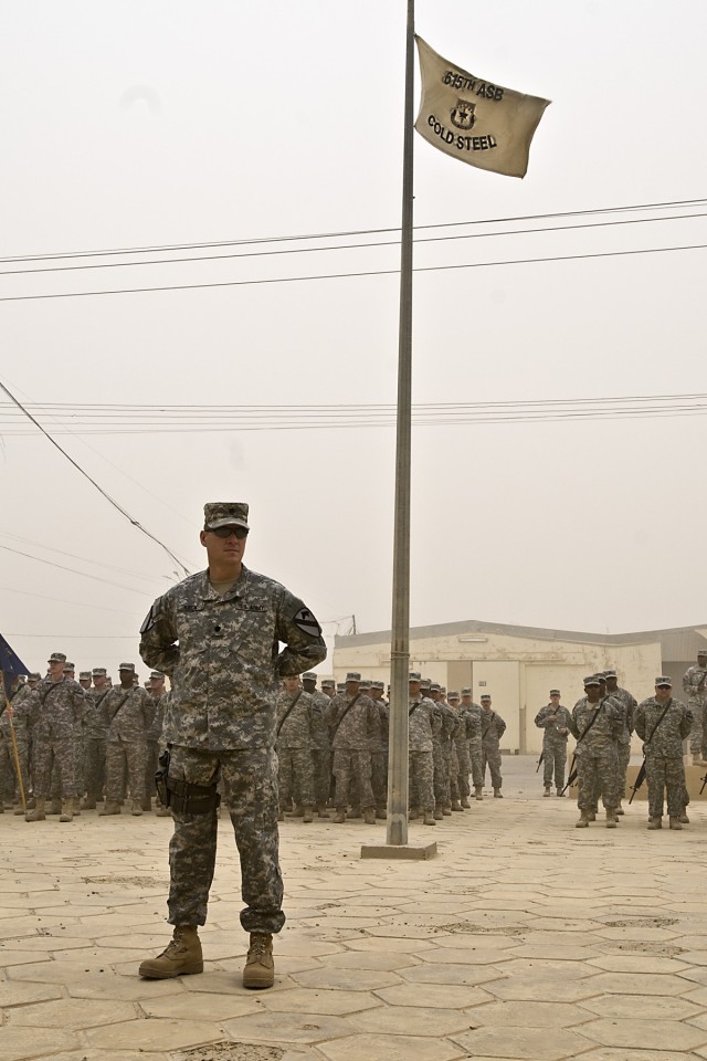 TAJI, Iraq - Lt. Col. Dean Keck, of Edmond, Okla., commander of 615th Aviation Support Battalion, 1st Air Cavalry Brigade, 1st Cavalry Division, Multi-National Division - Baghdad, stands before his battalion and battalion colors as they fly in the...