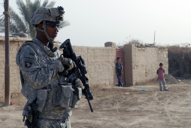BAGHDAD -Spc. Jeremy Taylor, a native of Baton Rouge, La., assigned to A Troop "Dawgs," 1st Battalion, 150th Armor Reconnaissance Squadron, 30th Heavy Brigade Combat Team, stands guard as his fellow Soldiers sweep for weapon caches in the village of ...