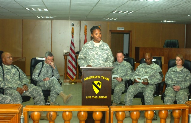 BAGHDAD -  Portsmouth, Va. native, Chief Warrant Officer 2 Tujuanna Johnson (center), legal administrator, 1st Cavalry Division, Multi-National Division-Baghdad, welcomes a crowd gathered for the dedication ceremony of the new MND-B courtroom at Camp...