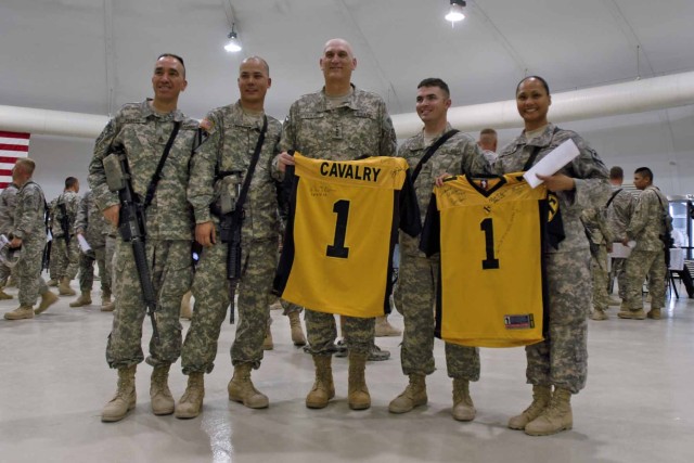 MOSUL, Iraq - The 3rd "Greywolf" Heavy Brigade Combat Team, 1st Cavalry Division Reenlistment team poses for a photo with Gen. Ray Odierno, the commanding general of Multi-National Forces - Iraq who signed football jerseys for the crew. Odierno...