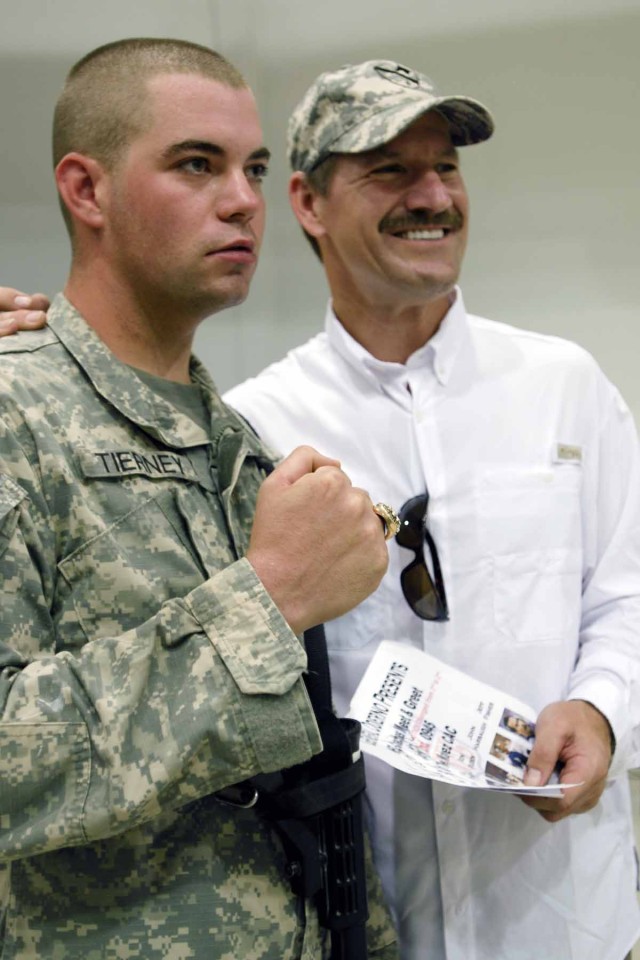 MOSUL, Iraq - Pfc. Sean Tiernney, an infantryman with Headquarters and Headquarters Troop, 3rd "Greywolf" Heavy Brigade Combat Team, 1st Cavalry Division and native of Providence, R.I., poses with Bill Cowher, the former National Football League...