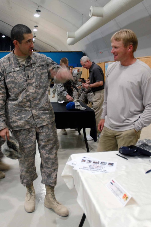 MOSUL, Iraq - 1st Sgt. John Pulido, the first sergeant of Headquarters and Headquarters Troop, 3rd Heavy Brigade Combat Team Special Troops Battalion, 1st Cavalry Division and a native of Montclair, Calif., chats with Jon Gruden, the former...