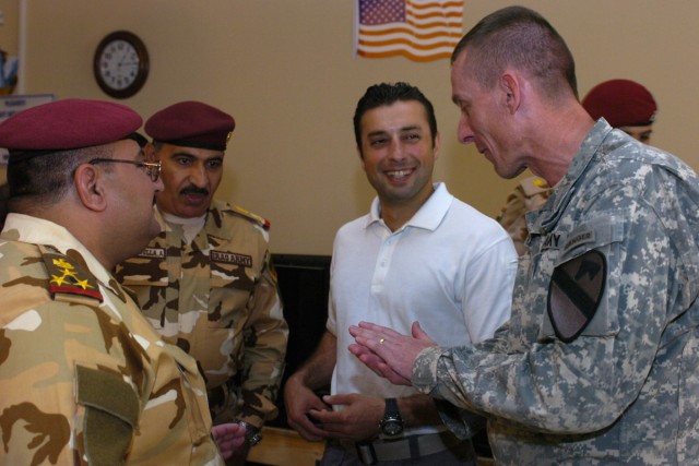 Col. Gary Volesky, the commander of the 3rd Heavy Brigade Combat Team, 1st Cavalry Division, speaks with senior Iraqi Security Forces officers during a luncheon held on July 4. The event was a celebration of Independence Day and the handover of secur...