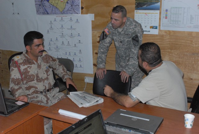 2nd Lt. Nabil Abdulla Mahmood, a Kurdish Army liaison, talks with Capt. Elmo Orta, and the Iraqi security forces logistic officer for 2nd Brigade Combat Team, 1st Cavalry Division. Mahmood is part of a group of liaisons from various Iraqi military an...
