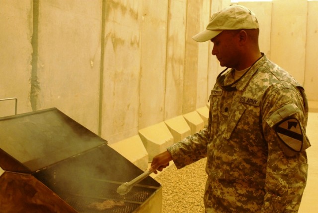 Lt. Col. Flint Patterson, the executive officer of 2nd Brigade, 1st Cavalry Division, cooked up a traditional Fourth of July meal of hotdogs, steaks, hamburgers and more, to celebrate the holiday on Forward Operating Base Warrior, Kirkuk, Iraq. Ameri...