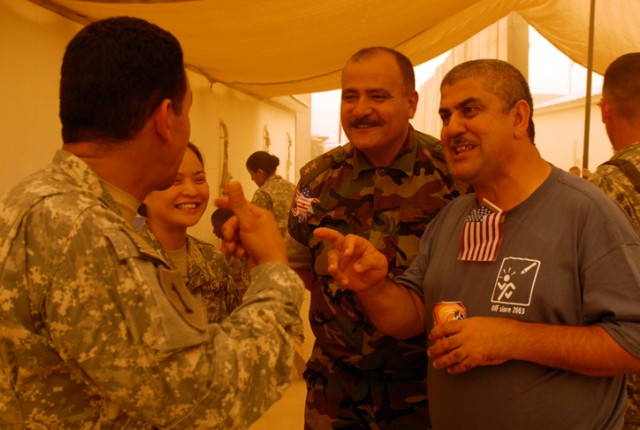 1st Lt. Saba Galeb Ali (center right), a member of the Kurdish Army who acts as a liaison officer with 2nd Brigade Combat Team, 1st Cavalry Division, celebrates Independence Day with Soldiers at Forward Operating Base Warrior, in Kirkuk, Iraq. Ali, a...
