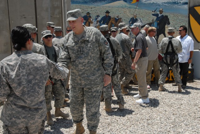 Gen. Raymond Odierno, commander of Multi-National Forces Iraq, shook hand with Soldiers and interpreters during his visit to Forward Operating Base Warrior, Kirkuk, Iraq, July 2. Odierno was accompanied by five legendary NFL coaches that gave autogra...