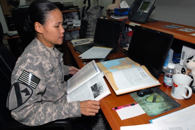 BAGHDAD - Sgt. Magdalena Sweesy, the executive administrative noncommissioned officer for Brig. Gen. Frederick Rudesheim, deputy commanding general for support,1st Cav. Div., Multi-National Division-Baghdad, makes effective use of her free time by...