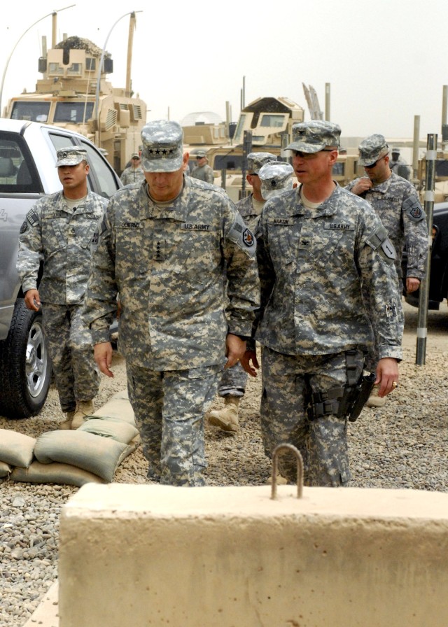BAGHDAD - Gen. Raymond Odierno (left), commander, Multi-National Force - Iraq walks alongside Col. Joseph Martin, a native of Dearborn, Mich., commander, 2nd Heavy Brigade Combat Team, 1st Infantry Division, Multi-National Division - Baghdad July...